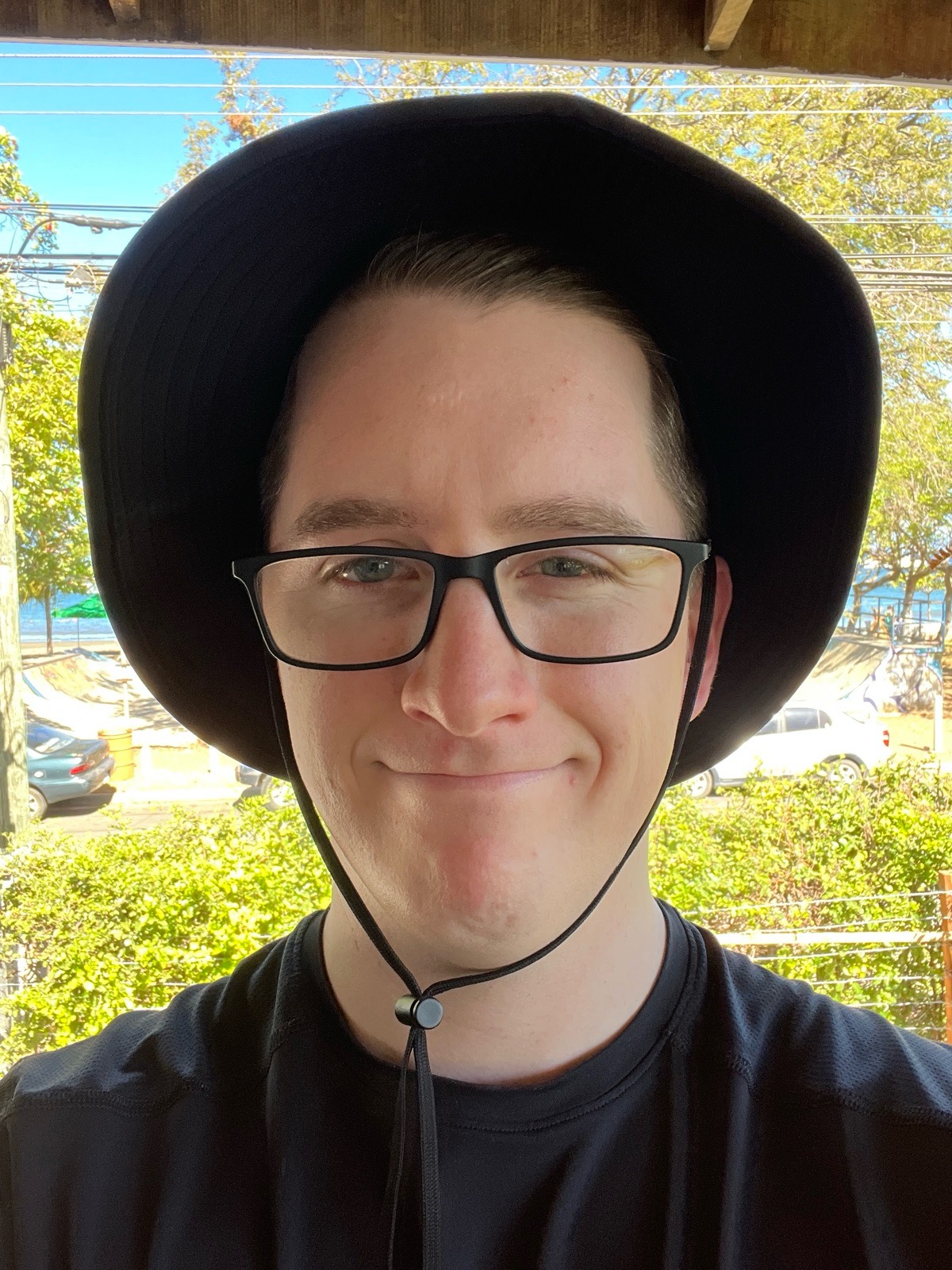 Matthew in a hat, looking pleased with himself.