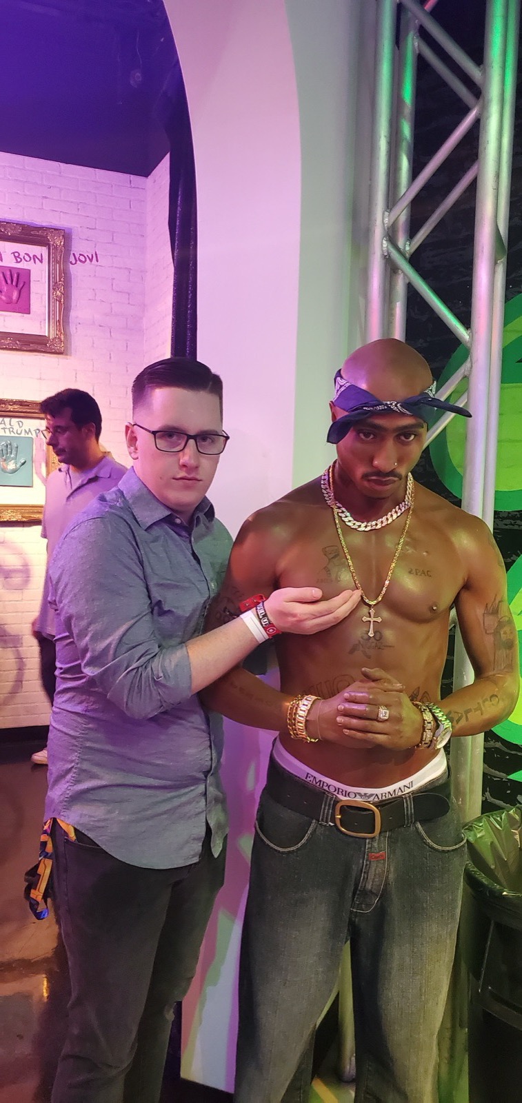 Matthew standing in front of a Tupac mural.